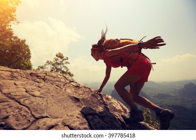 Young Asian Woman Hiker Climbing Rock On Mountain Peak Cliff