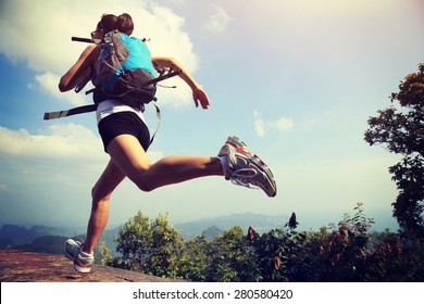 Young Asian Woman Hiker Running On Mountain Peak Cliff