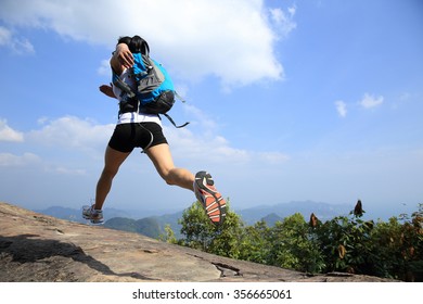 Young Asian Woman Hiker Running On Mountain Peak Cliff