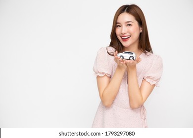 Young Asian Woman Holding Car Model Isolated On White Background, Travel Insurance Concept