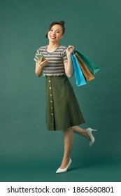 Young Asian Woman Holding Colorful Shopping Bags.