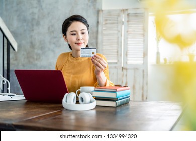 Young Asian Woman Holding A Credit Card.