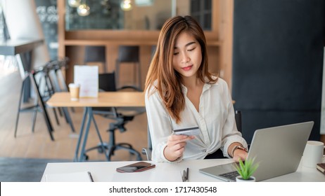 Young Asian Woman Holding Credit Card And Using Laptop. Online Shopping Concept.