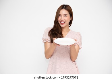 Young Asian Woman Holding Empty White Plate Or Dish Isolated On White Background