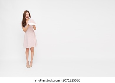 Young Asian woman holding empty white plate or dish isolated on white background, Full body composition