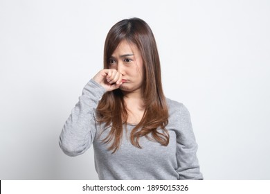 Young Asian Woman  Holding Her Nose Because Of A Bad Smell On White Background