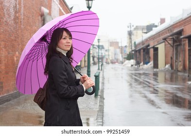 Young Asian Woman Holding Up Her Umbrella