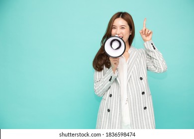 Young Asian Woman Holding Megaphone Isolated On Green Background, Speech And Announce Concept