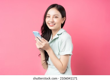 Young Asian Woman Holding Phone To Text	