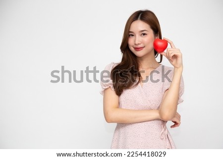 Young Asian woman holding red heart isolated on white background, Valentine day concept