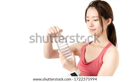 Young asian woman holding a water bottle.