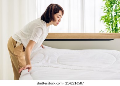 Young Asian Woman Housewife Clean Bed And Set Up Changing Bedsheet With White Clean Sheet Tidy Up Bedroom.room Service And Cleaning Concept