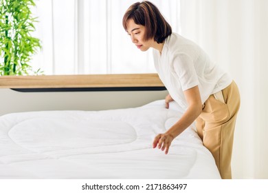Young Asian Woman Housewife Clean Bed And Set Up Changing Bedsheet With White Clean Sheet Tidy Up Bedroom.room Service And Cleaning Concept
