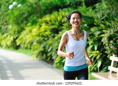 Young Asian Woman Jogging  At Park