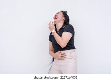 A young asian woman laughing out loud. Clutching her stomach from the hilarity and craziness. Isolated on a white backdrop. - Shutterstock ID 2227164035