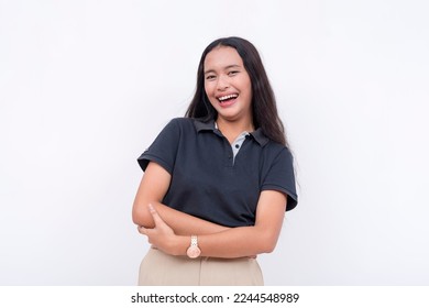 A young asian woman laughs from a joke while looking at the camera. A happy and lighthearted scene. Isolated on a white backdrop. - Shutterstock ID 2244548989