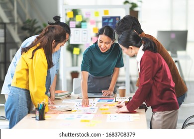 Young Asian woman leading business creative team in mobile application software design project. Brainstorm meeting, work together, internet technology, girl power, office coworker teamwork concept - Powered by Shutterstock
