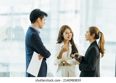 Young Asian woman leading business creative team in mobile application software design project. Brainstorm meeting, work together, internet technology, girl power, office coworker teamwork concept - Shutterstock ID 2140980859
