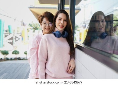young asian woman LGBTQ lesbian couple have fun in their journey on vacation day in the urban. concept for LGBTQ lifestyle, cohabitation, relationship etc                                  