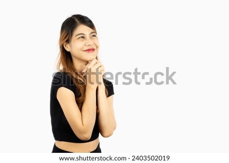 Young asian woman long hair style in black crop top posing make a wish isolated on white background.