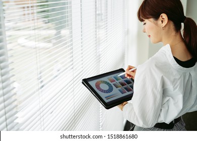 Young Asian Woman Looking A Color Chart.