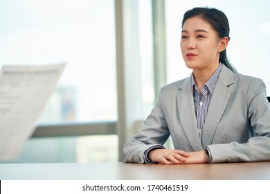 Young Asian Woman Looking For Employment Talking To Interviewer During Job Interview