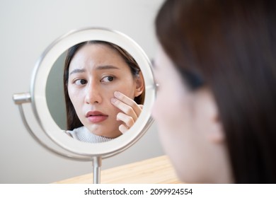 Young Asian Woman Looking In The Mirror Worried About The Crack Face Skin And Dark Circle Eyes.