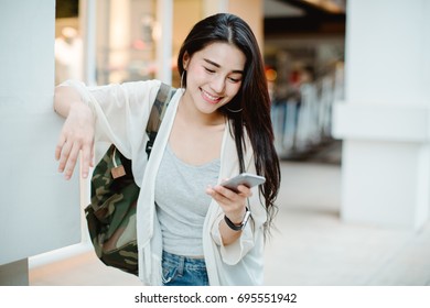  Young Asian Woman Looking At Mobile Smartphone,shopping Mall