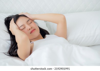 Young Asian Woman Lying On Bed Pain Headache In The Bedroom At Home, Unhappy Female Exhaustion And Sick Headache, Anxiety And Unwell, Dizziness And Disorder, Medical And Health Concept.