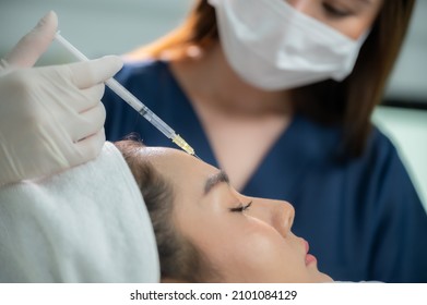 young Asian woman making cosmetology treatment skin injection, Mesotherapy of face beauty care - Powered by Shutterstock