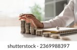 Young Asian woman making stack of coin. invest save finance concept, saving money, investment