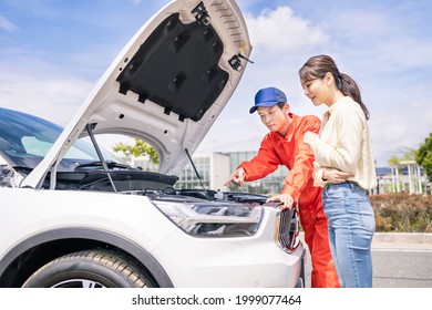 Young Asian Woman And Mechanic Opening Bonnet Of Car. Road Service. Roadside Assistance.