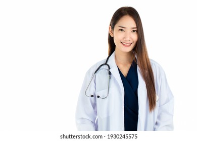 Young Asian woman in medical robe smiling and looking at camera during work against white background