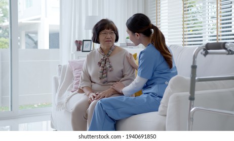 Young Asian Woman Or Nurse Home Care Hand On Senior Grandmother Shoulder Give Support Empathy To Elderly Lady Or Older People In Assisted Living Homecare Mental Health Sick Relief Concept.