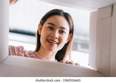 Young Asian Woman Opens The New Package That Has Been Sent Home
