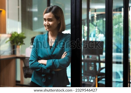 Young Asian woman. Portrait confident asian women smiling looking at camera at modern smallbusiness home office