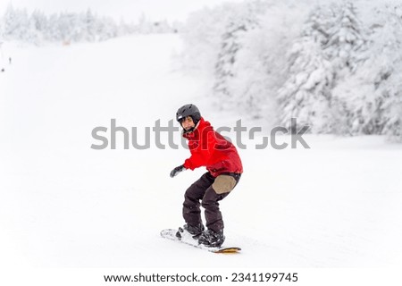 Young Asian woman practice downhill sliding snowboard on snow mountain at ski resort. Attractive girl enjoy outdoor active lifestyle travel nature and winter extreme sport training on holiday vacation