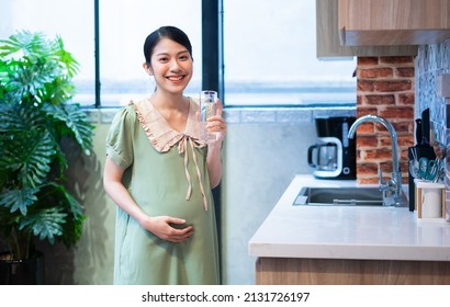 Young Asian woman pregnant relax at home