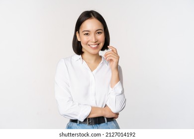 Young asian woman, professional entrepreneur standing in office clothing, smiling and looking confident, white background - Shutterstock ID 2127014192