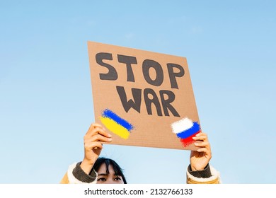 Young Asian Woman Protesting Against Russian Army Invasion Of Ukraine - Stop Ukrainian War