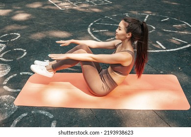 Young Asian Woman Pumping Press At The Outdoors Sports Ground.