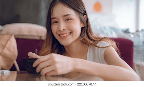 Young Asian Woman Putting Mascara Makeup In Mirror Banner Getting Ready For Work Doing Morning Makeup Routine Putting Mascara In Bathroom Mirror At Home.