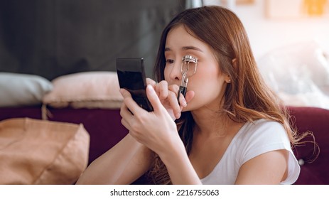 Young Asian Woman Putting Mascara Makeup In Mirror Banner Getting Ready For Work Doing Morning Makeup Routine Putting Mascara In Bathroom Mirror At Home.