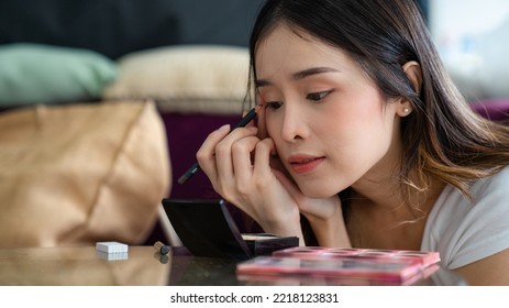 Young Asian Woman Putting Mascara Makeup In Mirror Banner Getting Ready For Work Doing Morning Makeup Routine Putting Mascara In Bathroom Mirror At Home.