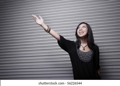 Young Asian Woman Reaching Towards The Light