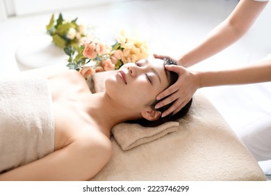 Young asian woman receiving head spa - Powered by Shutterstock