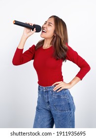 Young Asian Woman In Red Long Sleeve T-shirt Singing With Microphone.