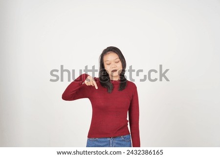 Young Asian woman in Red t-shirt Pointing down at copy space isolated on white background
