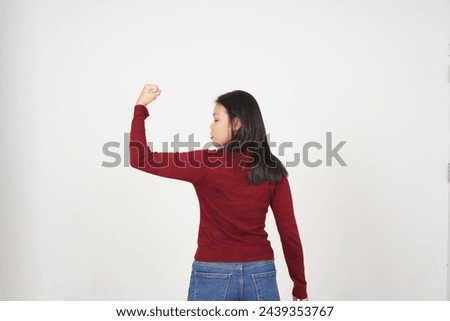 Young Asian woman in Red t-shirt Showing strong arms, emancipation of women concept isolated on white background