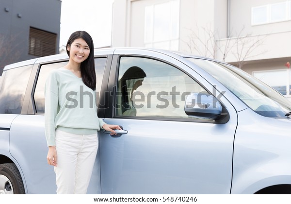 young asian woman relax with\
car